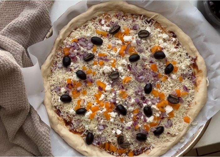 Pizza dough with fresh toppings